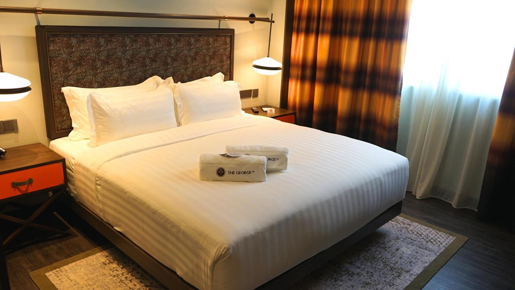 Hotel The George Penang By The Crest Collection George Town Exterior foto A bed in a hotel room